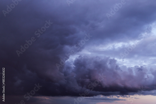Epic Dramatic Storm sky with dark grey blue violet cumulus rainy clouds abstract background texture, thunderstorm