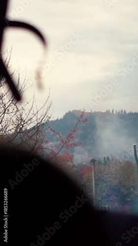 A beautiful view of nature from a train window during a journey. A railway in the mountains.