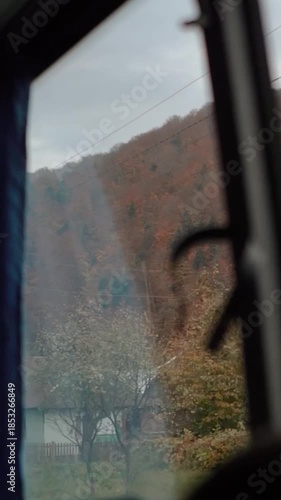 A beautiful view of nature from a train window during a journey. A railway in the mountains.