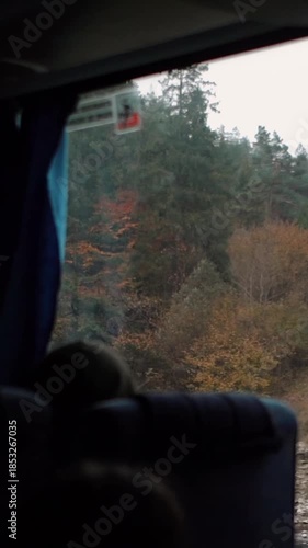 A beautiful view of nature from a train window during a journey. A railway in the mountains.