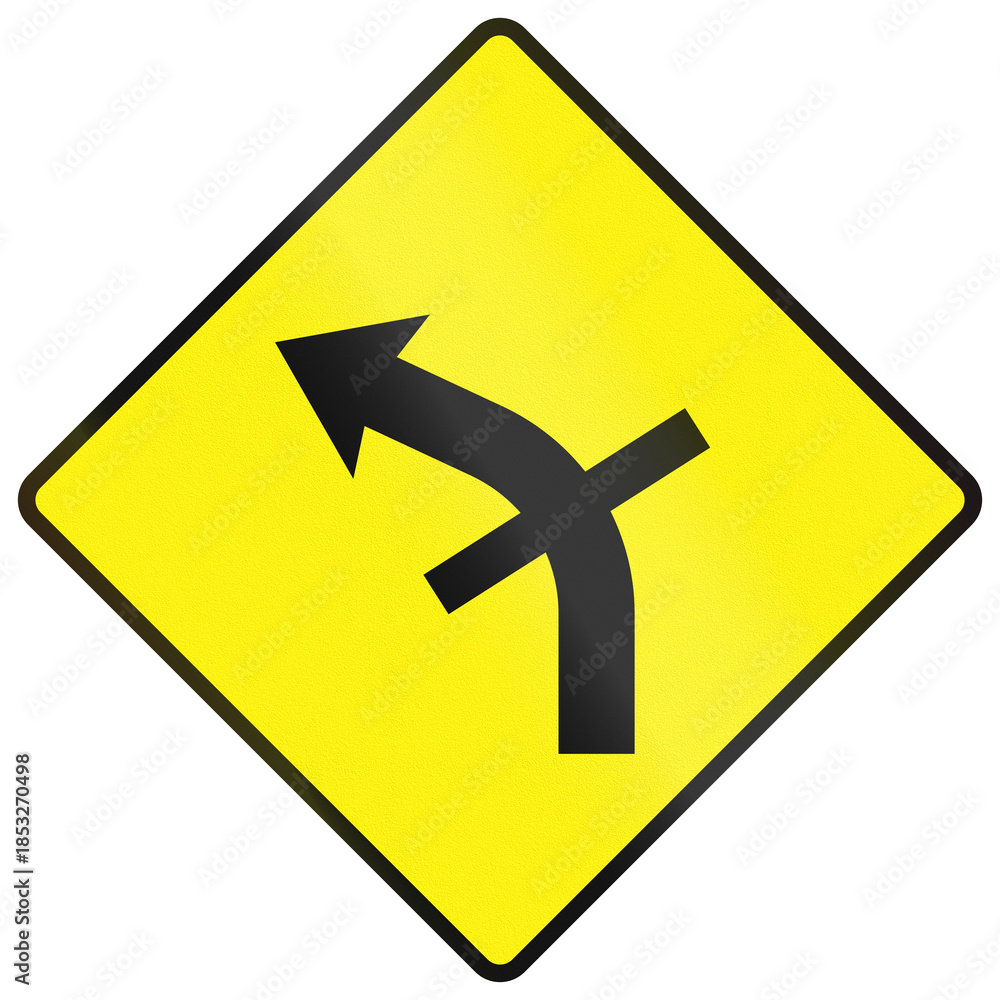 Fototapeta premium Warning road sign used in Ireland - Sharp bend to the left with a crossroads on the curve