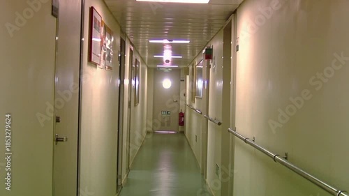 Ship Interior Corridor With Emergency Exit Sign, Safety Handrails and Fire Extinguisher  