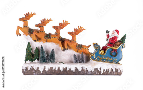 Santa Claus toy on a sleigh with reindeer isolated on white background