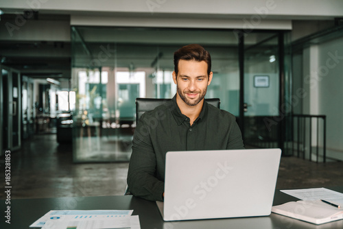 Bild auf Leinwand Young professional specialist latin hispanic businessman working on laptop pc sitting at desk in office