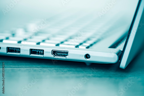 Keyboard of laptop and ports closeup.