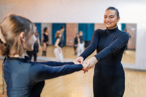 Dance instructor showing student dancing moves