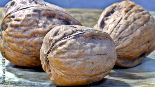 Heap of walnuts in shell, close-up, top view. Healthy eating. Harvest, agriculture. Walnuts, selective focus, background