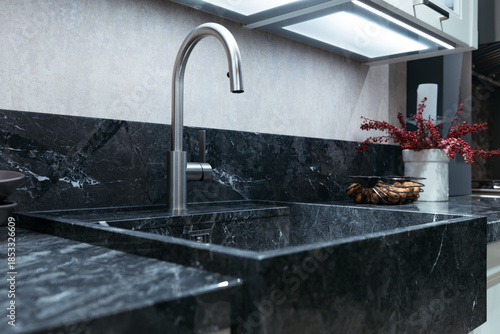 Stainless Steel Kitchen Faucet with Black Marble Sink and Countertop