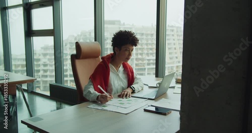 Business expert studying infrastructure projects with skyline backdrop
