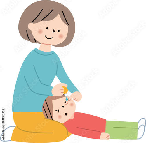子供に目薬を指すお母さん