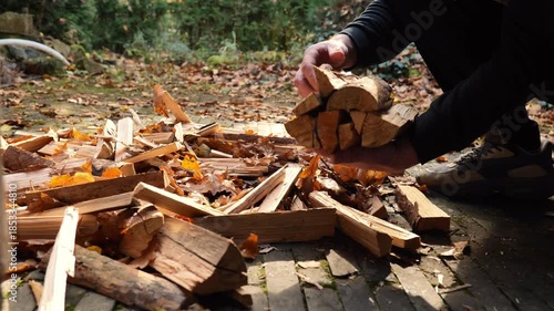 firewood for the fall heating season.a man collects chopped firewood.Solid natural heating fuel. 4k footage