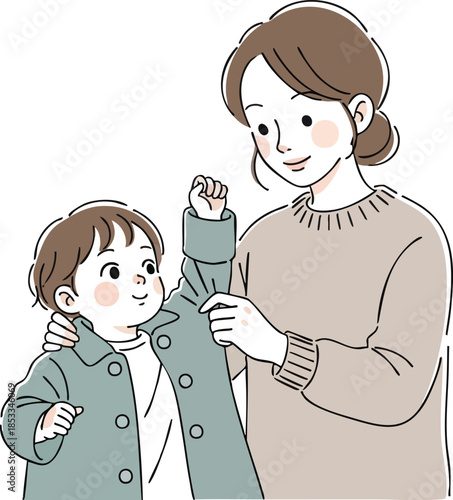 Mother helping young boy put on green coat indoors