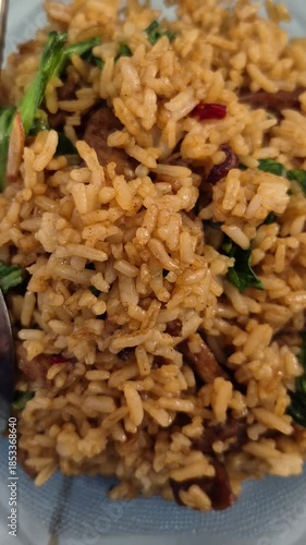 spicy fried rice with sliced ​​pak choy and meatballs