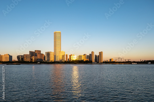 The urban riverside of Shanghai at dusk, with the skyscrapers of Pudong on the other side