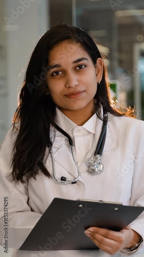 Young Indian female doctor writing medical report