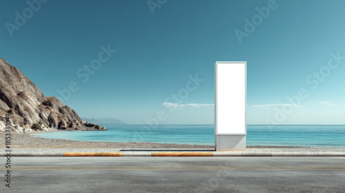 Modern vertical billboard with blank white display on coastal roadside