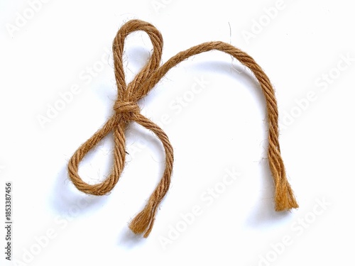 jute rope tied into a bow. Jute rope is a natural, plant-based fiber.