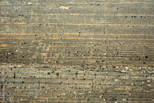A close-up of the chipped surface of a polished natural gray stone.