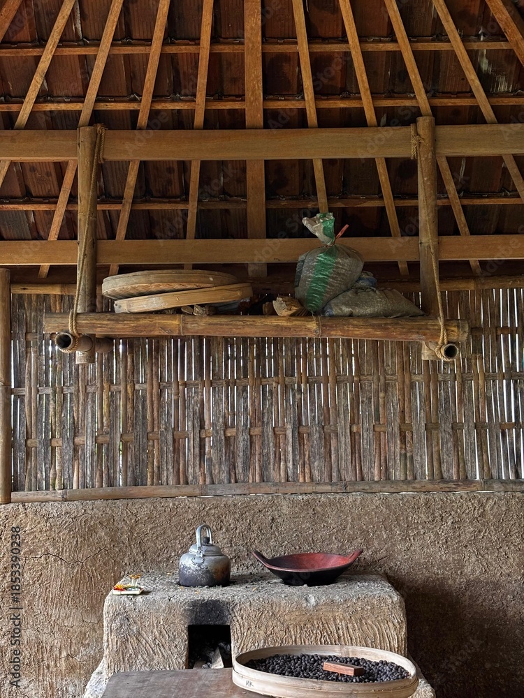 Obraz premium Traditional Clay Wood-Fired Stove with Metal Kettle and Clay Pan in a Rustic Rural Kitchen
