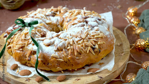 Festive Almond Christmas Cake with Powdered Sugar and Golden Lights