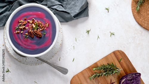 Vibrant Purple Cabbage Soup with Pecans and Rosemary Garnish