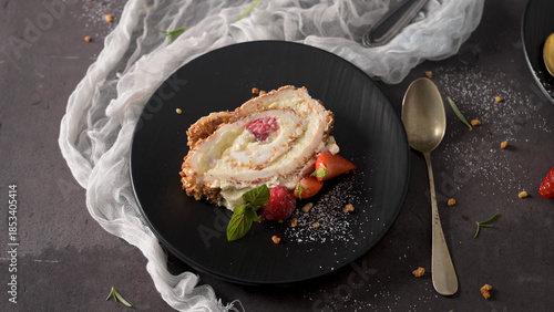 Slice of Berry Meringue Roulade with Fresh Raspberries and Mint