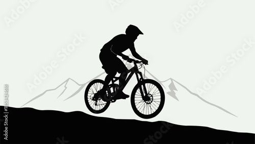 Silhouette of a mountain biker riding downhill on a trail.