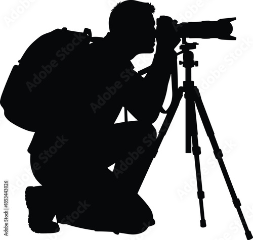 Man Kneeling with Tripod and Backpack Taking Photo with Telephoto Lens.