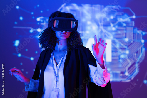 Woman wearing virtual reality headset explores digital world in a tech environment during a creative event at night