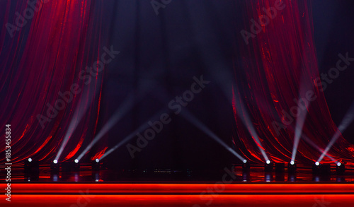 red curtains with a stage and spotlights for the background