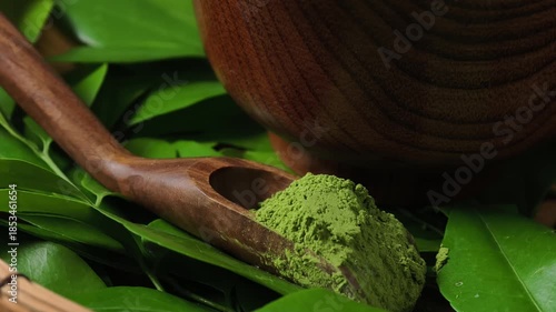 Matcha green tea in a wooden spoon.