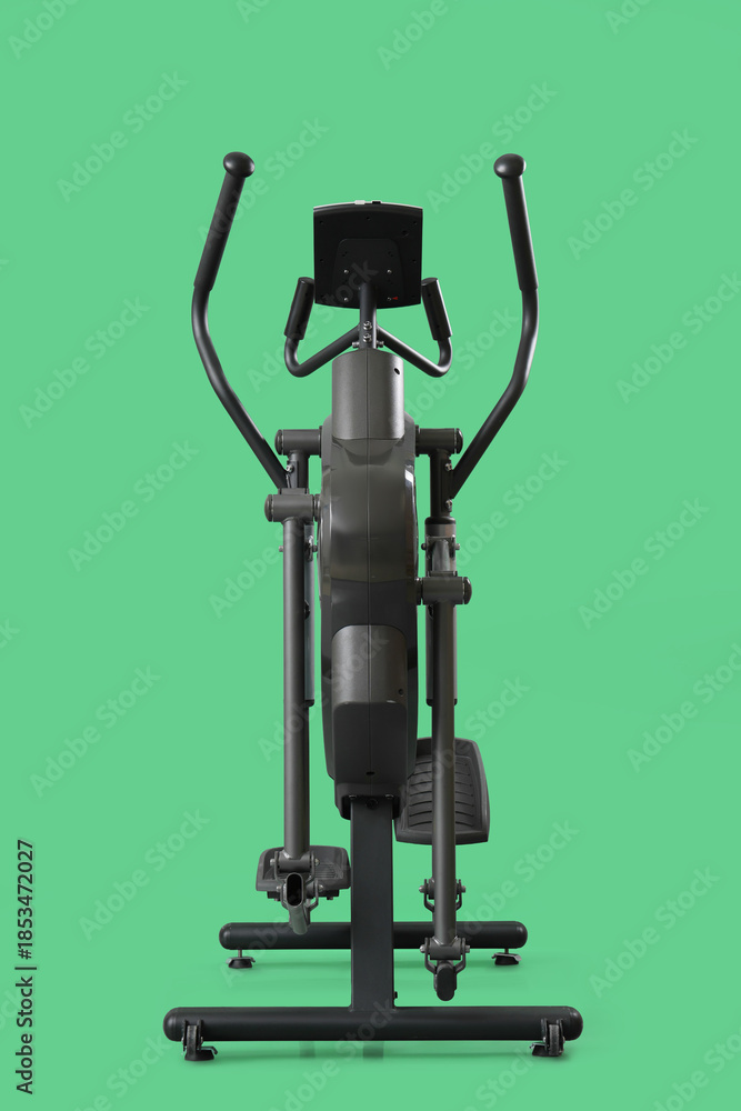 Naklejka premium Elliptical machine on green background
