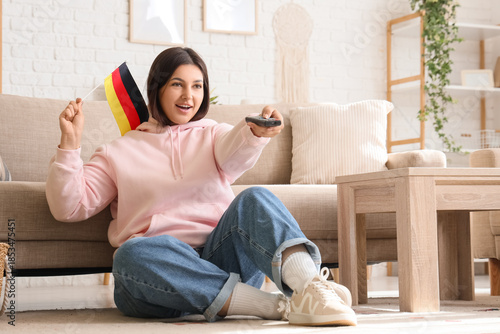 Young woman with remote con...