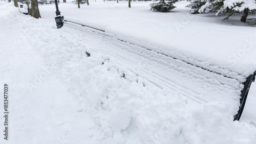 Snow Covered Benches in Winter City Park