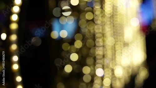Defocused Christmas tree lights softly changing on a black background, creating a warm festive atmosphere ideal for holiday video backgrounds or overlays.