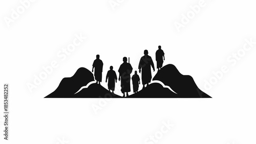 Group of people standing on a rock formation silhouette.