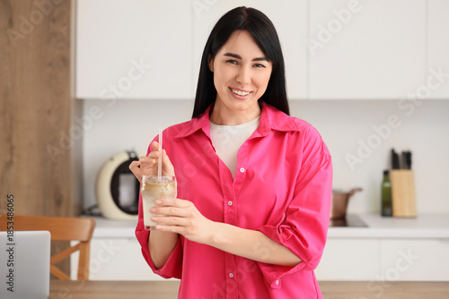 Young woman with glass of i...