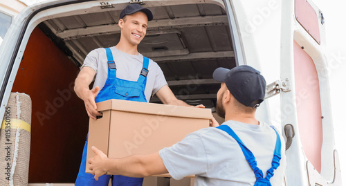 Bild auf Leinwand Male movers unloading box from car outdoors