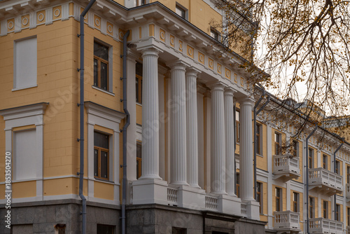 Classical yellow building facade with white columns