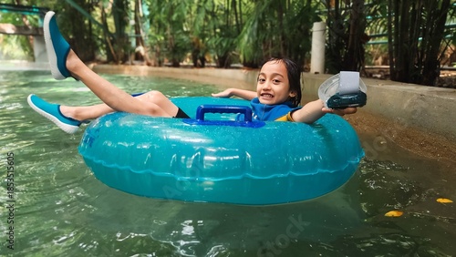 Little girl on the giant float in a water park in Malaysia.