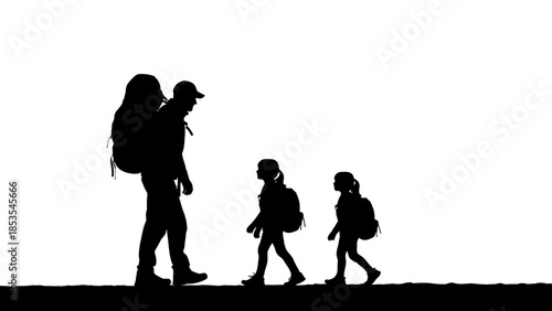 Silhouette of a mother carrying a child with two children walking forward