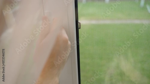 Hand opens window for ventilation and closes it, close-up