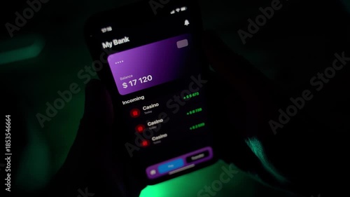 Casino sends money to balance on mobile app, close-up. Gambler in the dark receives payment from casino