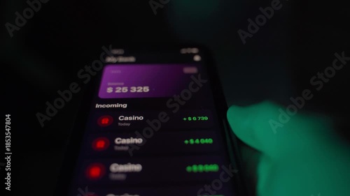 Waiting and receiving payment from casino to bank account via mobile app, close-up in the dark