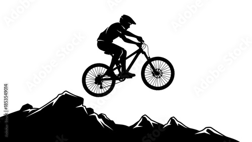 Silhouette of a mountain biker mid air against a dramatic mountain backdrop