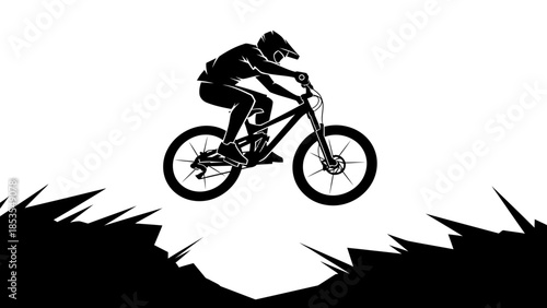 A silhouette of a mountain biker performing a jump in the air