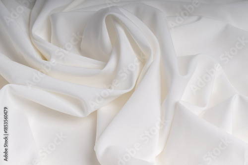 Minimalist white background made of soft fabric with beautiful folds.