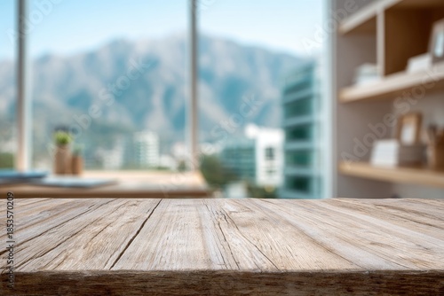 Light, airy room with wooden table and blurred mountain view