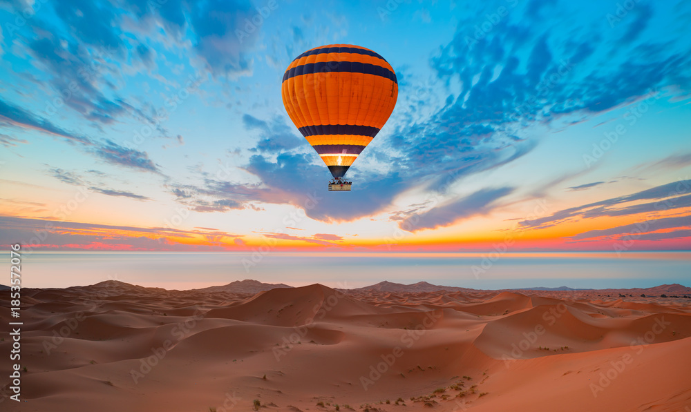 Fototapeta premium Hot air balloon flying over Sahara desert with Atlantic ocean meets - Sahara, Morocco