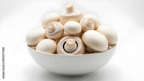 Fresh white button mushrooms neatly arranged in a white ceramic bowl, isolated on a clean white background for culinary use